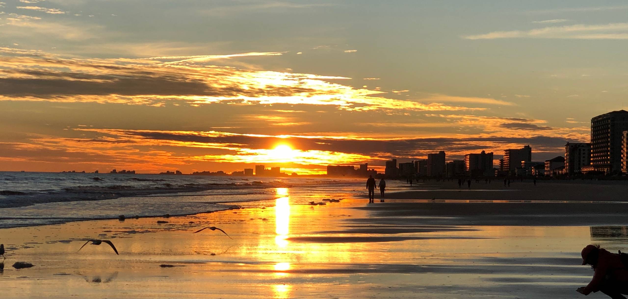 Scenery of beautiful sunset in North Myrtle Beach, South Carolina, along with water sky reflection